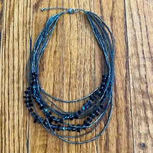 Silver/gray and black beaded 10 strand tiered necklace.